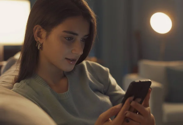 Smiling Teenager Relaxing Sofa Connecting Online Her Smartphone She Social — Stockfoto