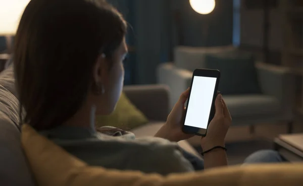 Young Woman Sitting Sofa Using Her Touch Screen Smartphone Blank — Stock fotografie