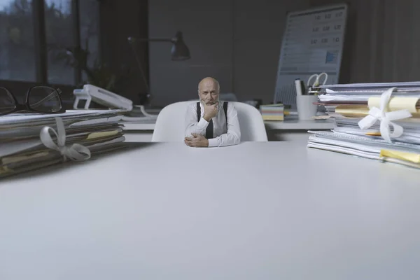 Tiny Businessman Sitting Office Desk Thinking Hand Chin Blank Copy — Zdjęcie stockowe