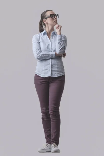 Ung Kvinna Poserar Och Tänker Med Handen Hakan Isolerad Grå — Stockfoto