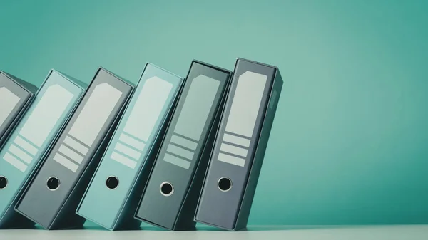 Falling ring binders on a shelf, data management and storage concept