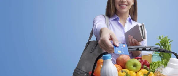 Mulher Segurando Uma Cesta Compras Completa Pagando Por Compras Usando — Fotografia de Stock