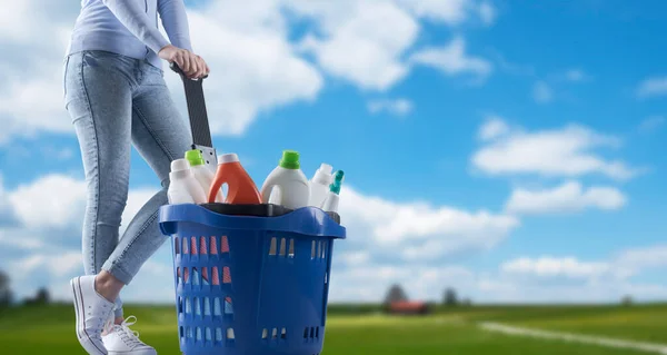 Vrouw Met Een Boodschappenmandje Vol Wasmiddelen Groen Landschap Achtergrond — Stockfoto