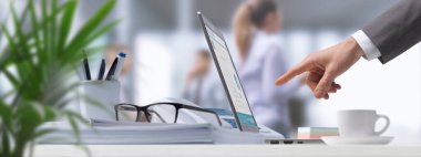 Ofiste çalışan şirket işadamı dijital dokunmatik ekran tabletine bağlanıyor ve bir iş uygulaması kullanıyor.