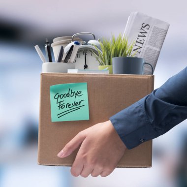 Office worker carrying personal belongings in a box after being fired, unemployment and career concept