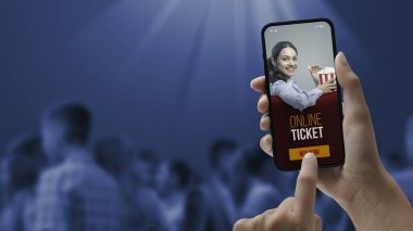 Woman holding a smartphone and buying movie tickets online using a mobile app, she is skipping the queue, POV shot