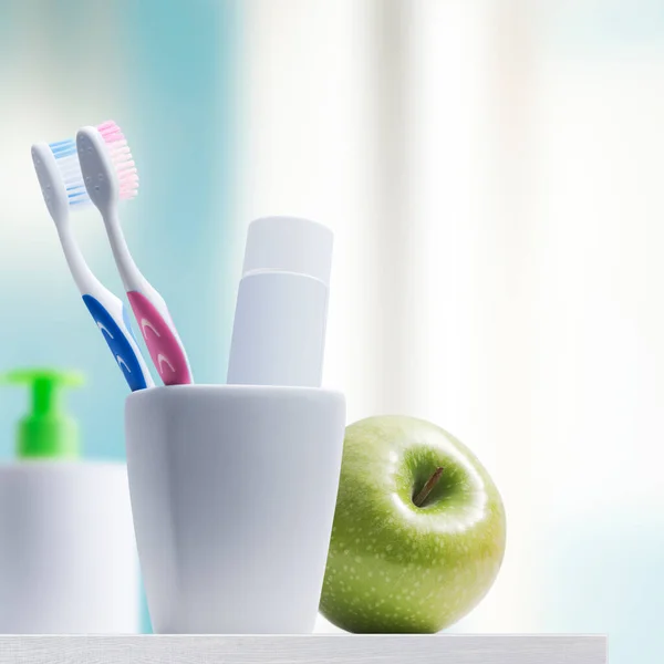 Toothbrush holder with toothbrushes and toothpaste, dental hygiene concept