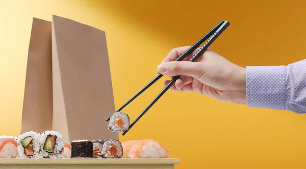 Woman Eating Sushi Using Chopsticks Food Delivery Bag Background — стоковое фото