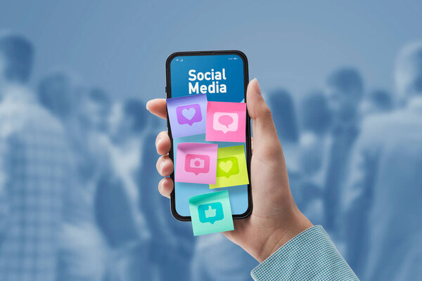 Woman connecting with social media online: sticky notes with icons on smartphone screen, POV shot