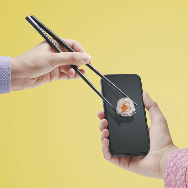 Hand Holding Smartphone Hand Holding Sushi Chopsticks Asian Food Delivery — Stockfoto