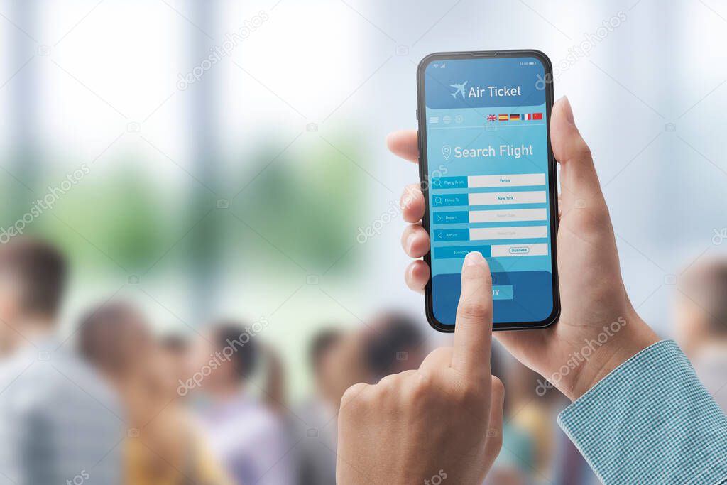 User holding a smartphone and booking cheap flights online, airport in the background, POV shot