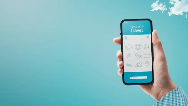 Hand holding a smartphone with travel app interface, blue sky in the background, travel and tourism concept, POV shot