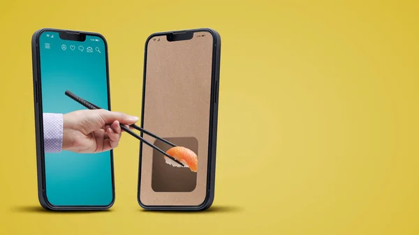 Sushi restaurant food delivery app on smartphone, user holding chopsticks and eating sushi