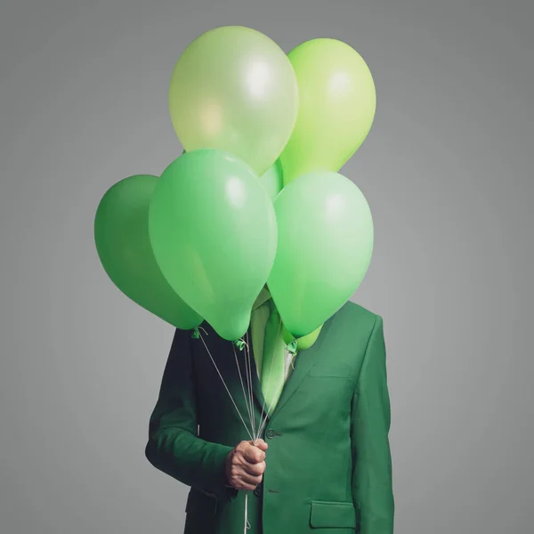 Corporate Businessman Hiding Green Balloons — Stock Photo, Image