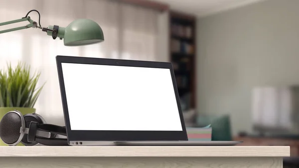 Laptop with blank screen on a desktop at home, room interior in the background, technology and communication concept