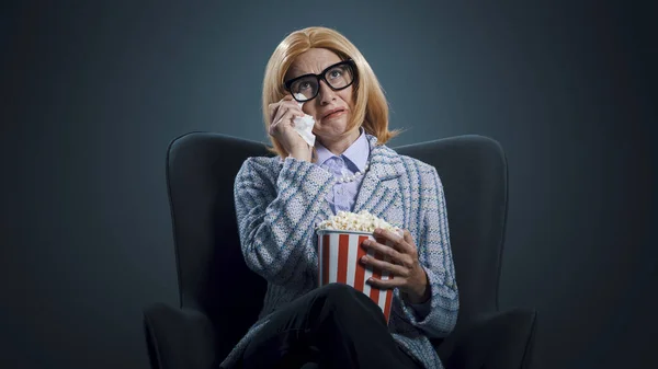 Woman at the movie theater, she is watching a drama movie and crying, cinema and entertainment concept