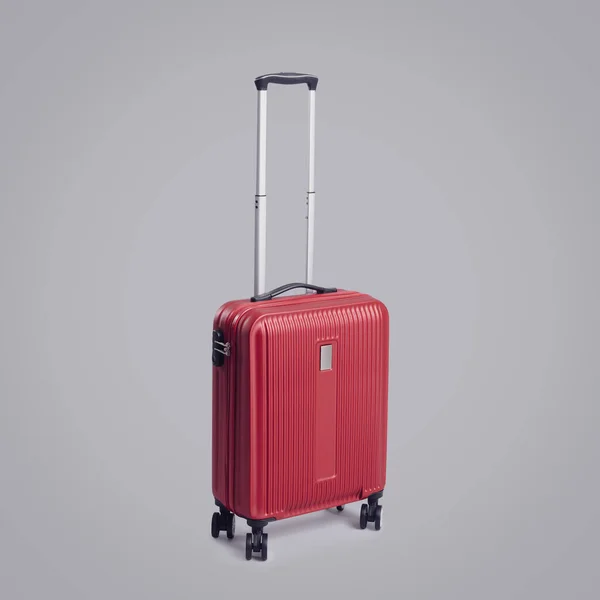 Stylish Red Rolling Suitcase Four Wheels Gray Background Travel Tourism — Stock Photo, Image
