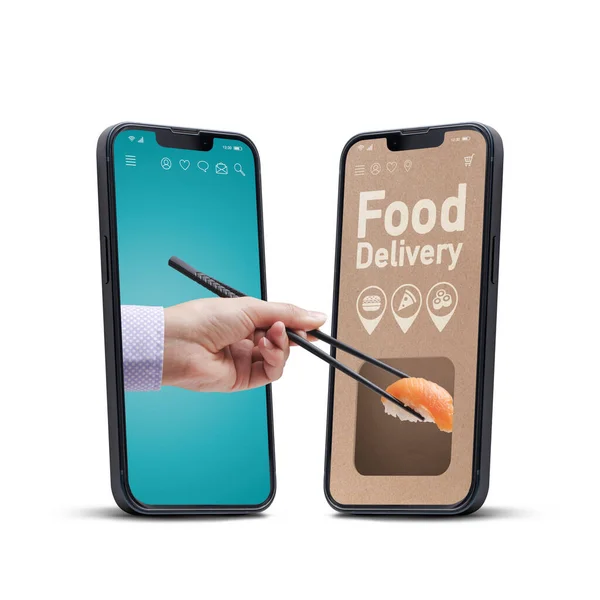 Sushi restaurant food delivery app on smartphone, user holding chopsticks and eating sushi