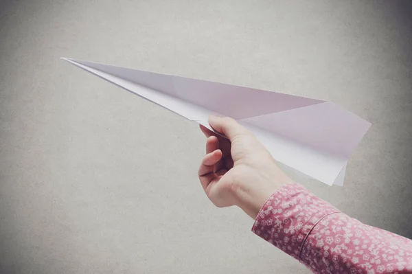 Kobieta Trzymająca Papierowy Samolot Szarą Ścianę Tle Koncepcja Kreatywności Wyobraźni — Zdjęcie stockowe