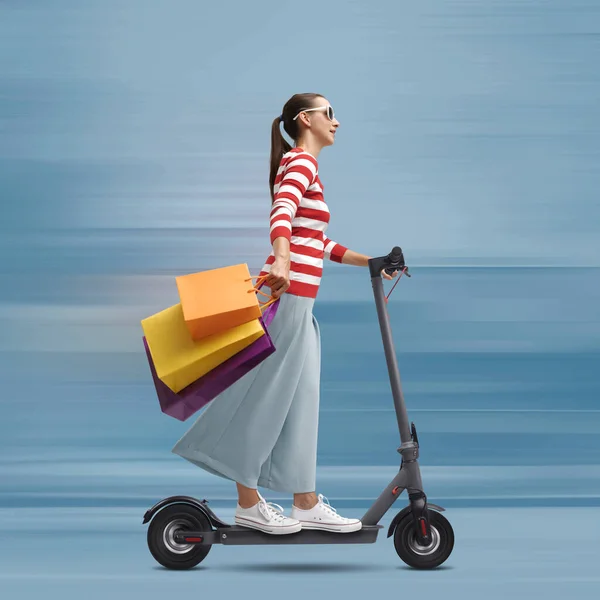 Young Woman Holding Many Shopping Bags Riding Fast Electric Scooter — Stock Photo, Image