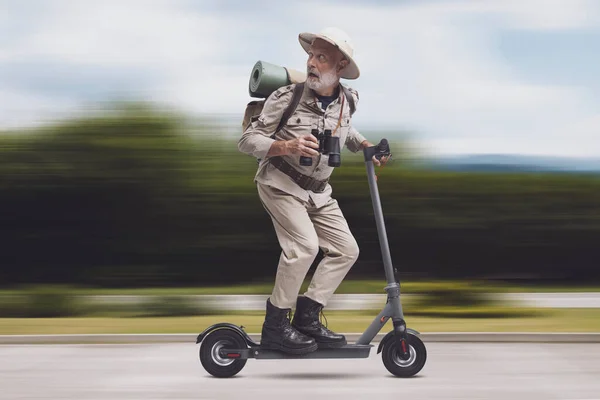 Funny scared explorer being chased by a monster, he is riding an electric scooter and running away