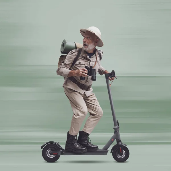 Funny scared explorer being chased by a monster, he is riding an electric scooter and running away