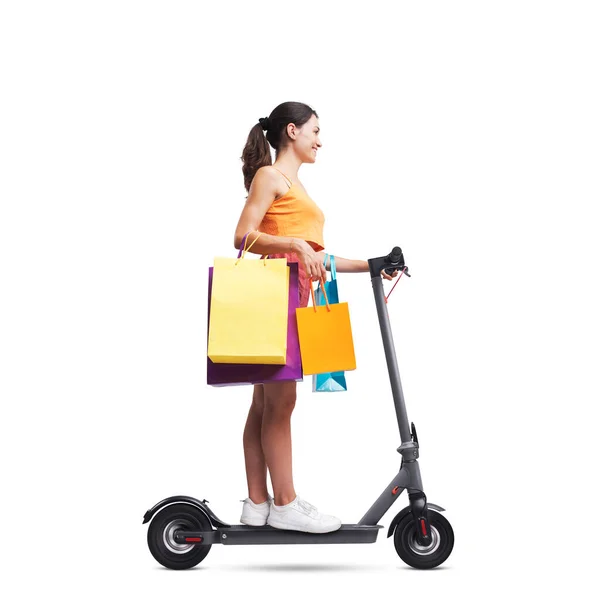 Fashionable Woman Holding Shopping Bags Riding Electric Scooter Isolated White — Stock Photo, Image