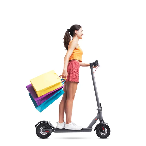 Fashionable Woman Holding Shopping Bags Riding Electric Scooter Isolated White — Stock Photo, Image