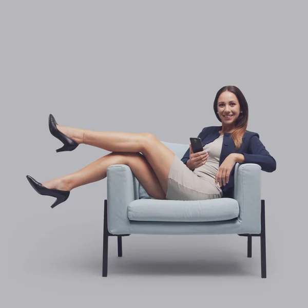 Confident Young Businesswoman Sitting Chair Feet Holding Smartphone She Smiling — Stock Photo, Image