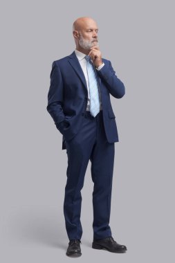 İşletme yöneticisi ayakta duruyor ve düşünüyor. Çene, iş stratejisi ve planlama konseptiyle.