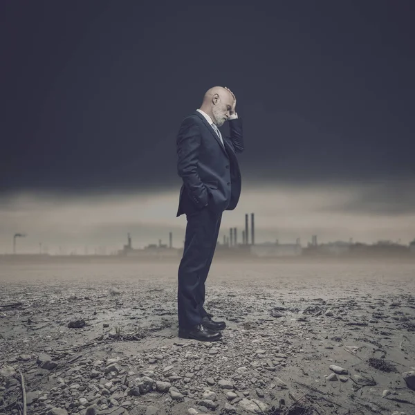 Desperate Corporate Businessman Stading Dry Barren Land Polluting Industries Background — Stock Photo, Image