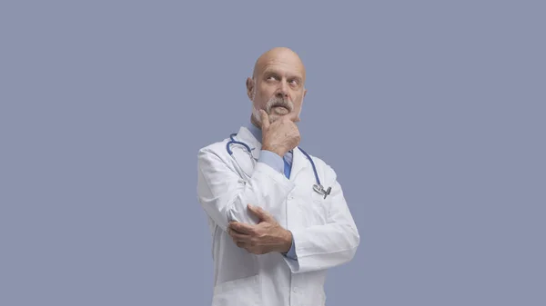 Starszy Lekarz Pozowanie Myślenie Medycyna Koncepcja Opieki Zdrowotnej — Zdjęcie stockowe