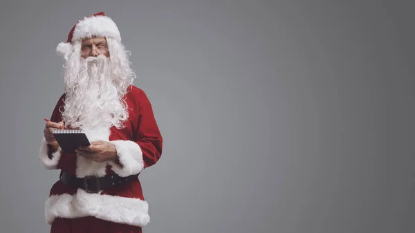 Pensivo Papai Noel Escrevendo Notas Lista Desejos Caderno Natal Feriados — Fotografia de Stock