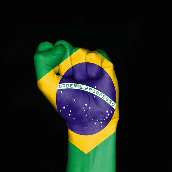 Brazil flag on fist over black background. Symbol of strength. — Stok fotoğraf