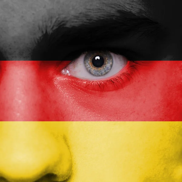 Cara humana pintada con bandera de Alemania — Foto de Stock
