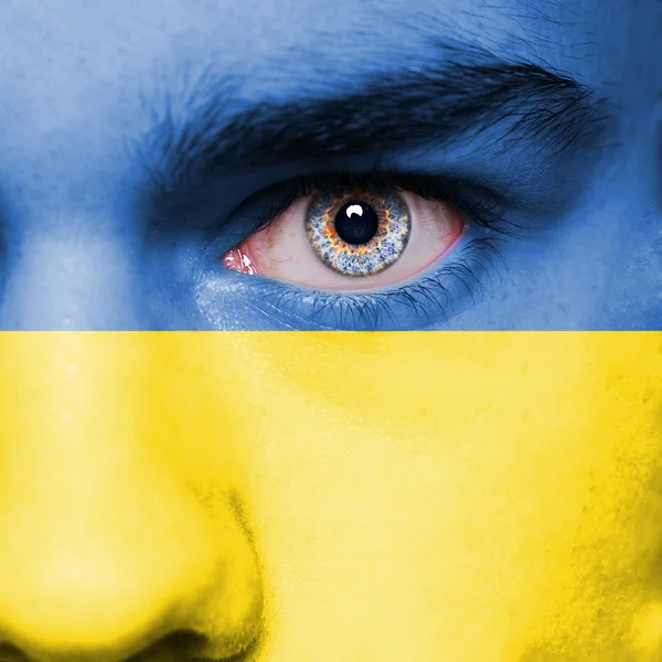 Ukraine flag painted on face — Stock Photo, Image