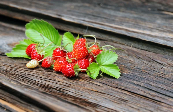 Fragole selvatiche su sfondo di legno — Foto Stock