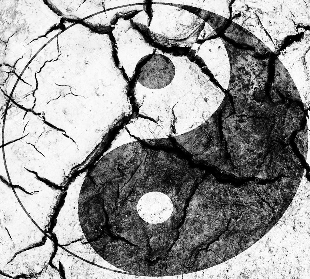 The Ying Yang sign painted on cracked earth wall