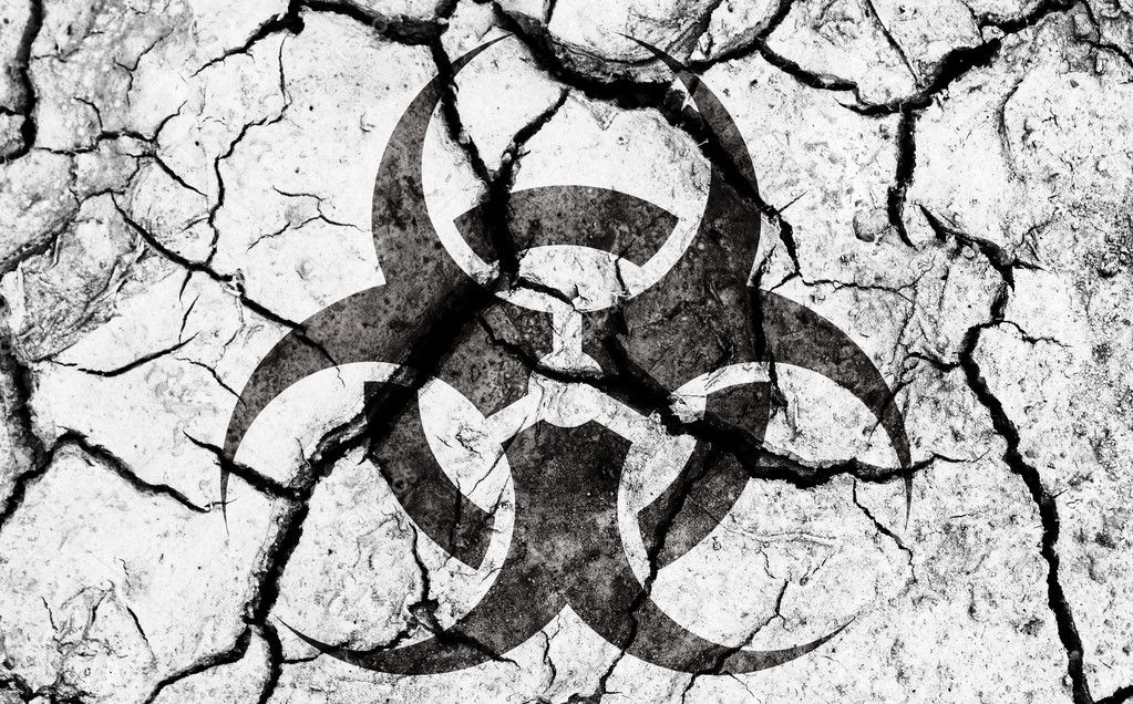 Biohazard sign on cracked earth texture
