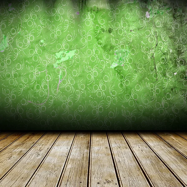 Dark room with green wall with pattern on it — Stock Photo, Image