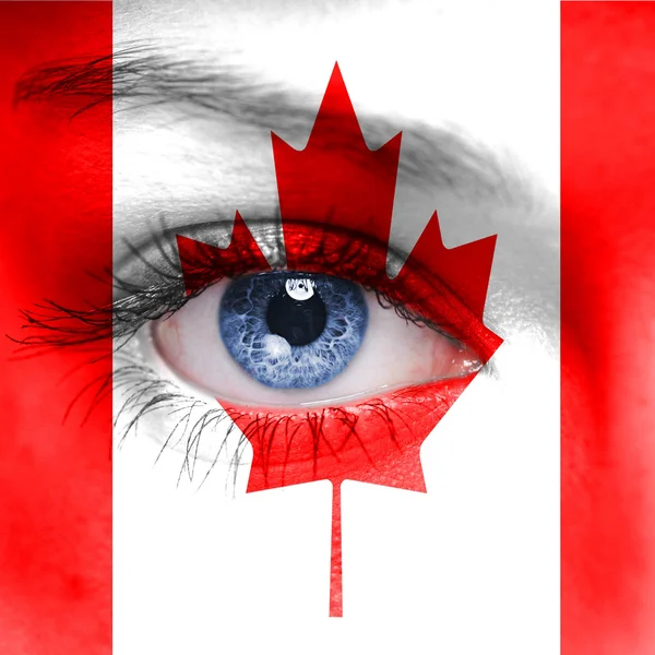 Lidská tvář s kanadská vlajka — Stock fotografie