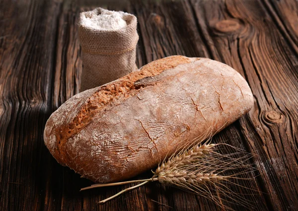 Baked bread on wood table — Stock Photo, Image