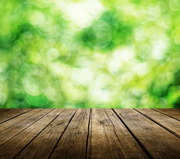 Table over beautiful green background — Stock Photo, Image