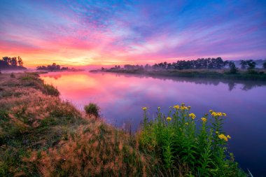 Colorful sunrise over the river banks