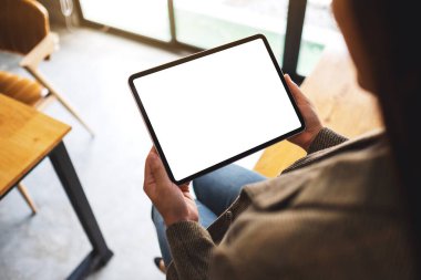 Boş beyaz masaüstü ekran ile siyah tablet pc taşıyan bir kadının en üst görünüm görüntüsü 