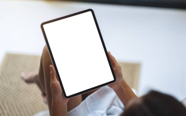 Boş beyaz masaüstü ekran ile siyah tablet pc taşıyan bir kadının en üst görünüm görüntüsü 