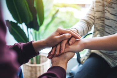 Bir erkek ve bir kadın, rahatlık ve sevgi için el ele tutuşuyorlar.