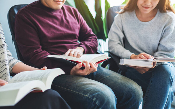 Group of young people sitting and enjoyed reading books together