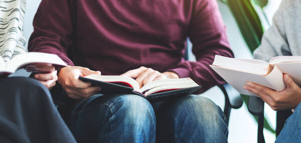 Group of young people sitting and enjoyed reading books together