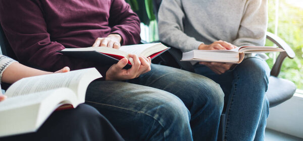 Group of young people sitting and enjoyed reading books together